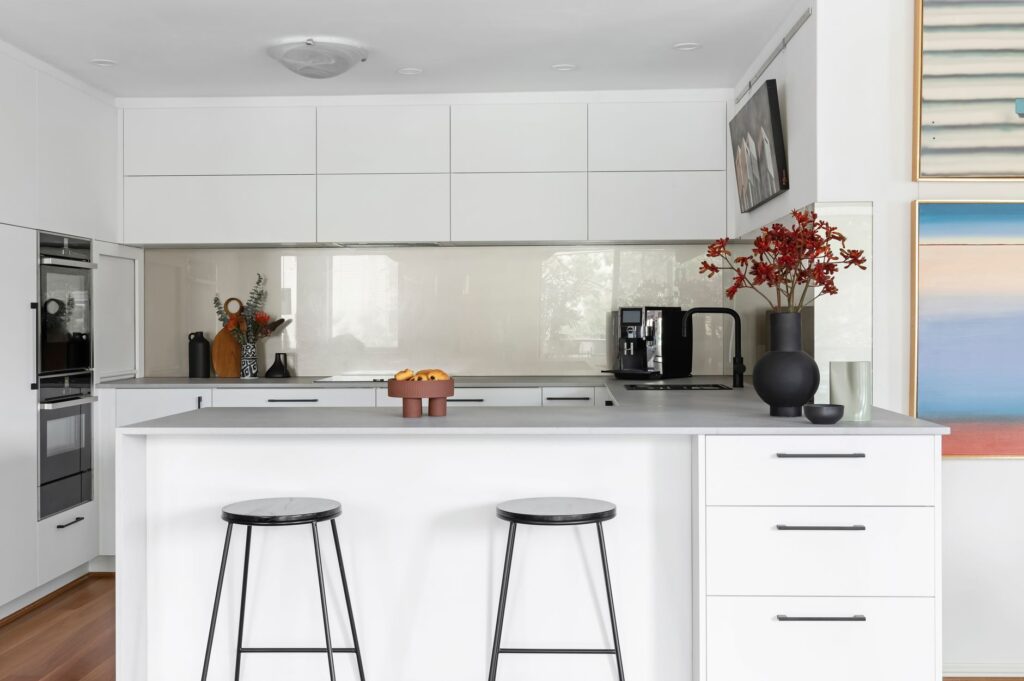 white kitchen with glass splashback