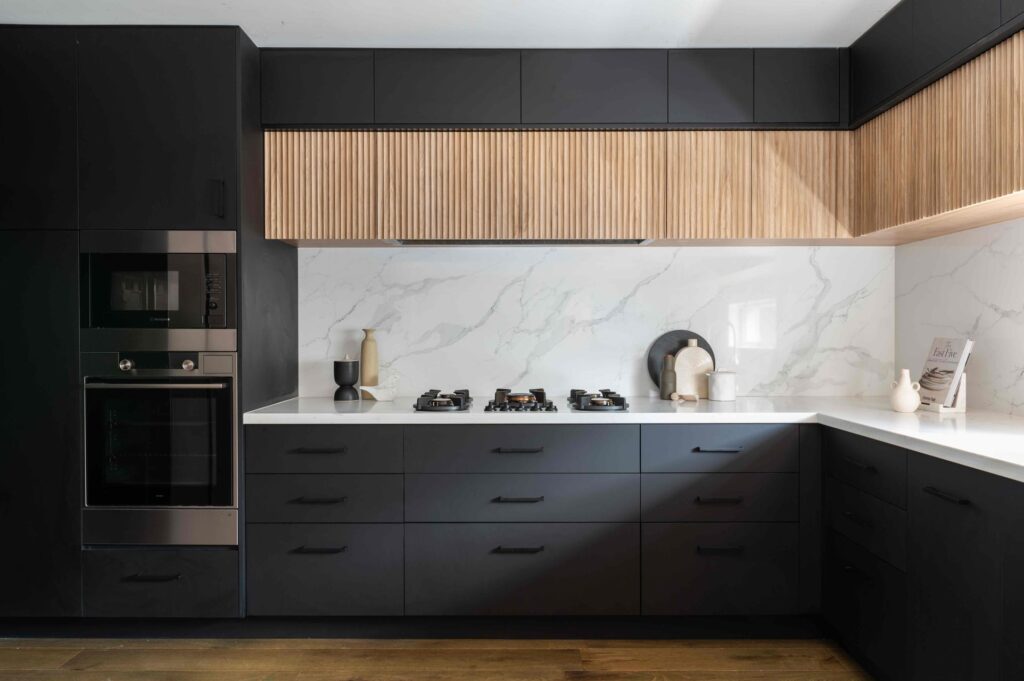 DGW Stone Splashback. Black Cabinetry.