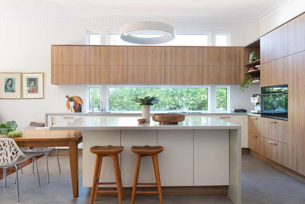 Natural Kitchen with wooden custom cabinetry and a window splashback