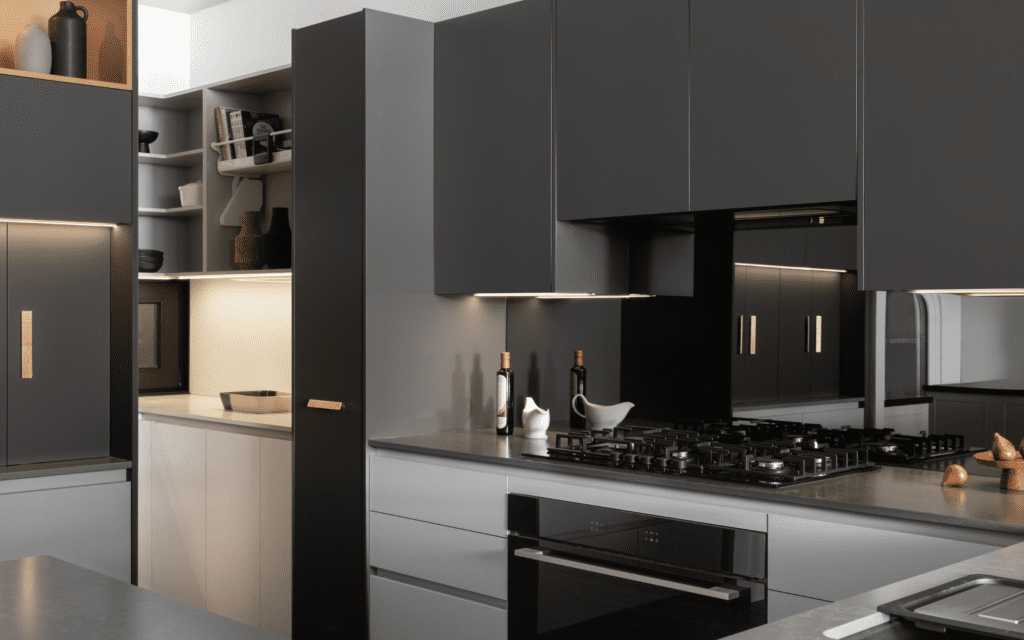 smoked mirror splashback with matte black cabinetry