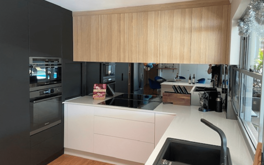 smoked mirror splashback with natural timber cabinets