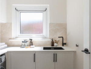 white laundry with stone splashback