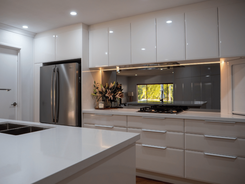 low e reflective glass splashback in coastal kitchen